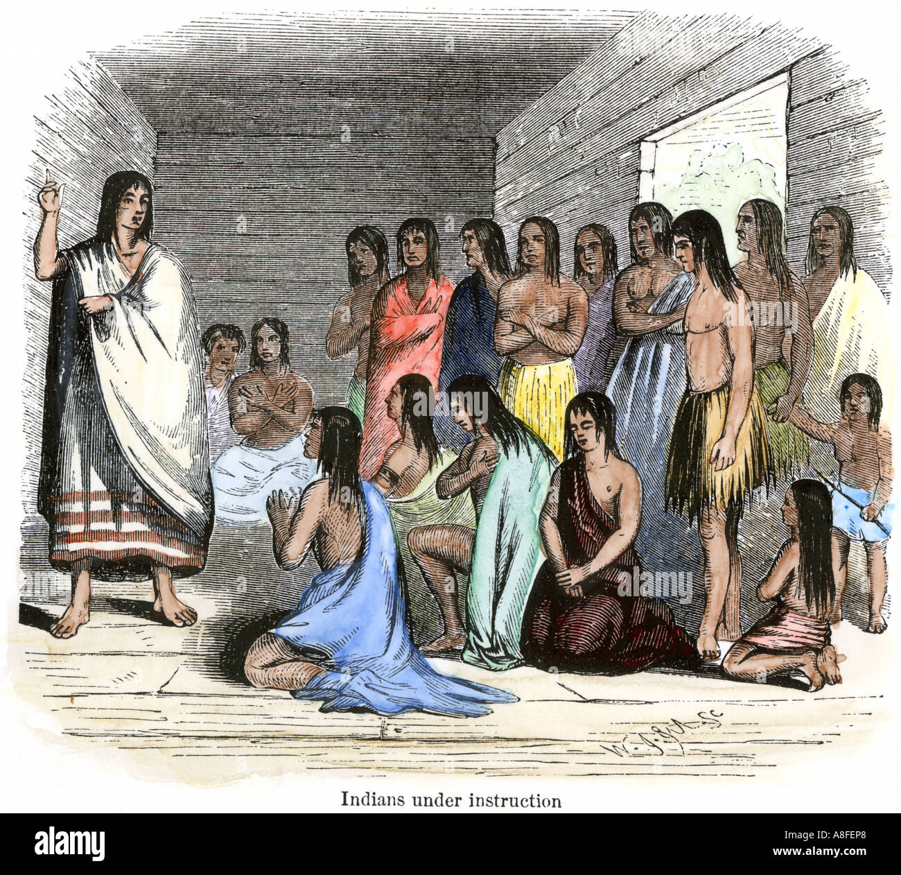 Native Americans under instruction in a Spanish mission. Hand-colored woodcut Stock Photo