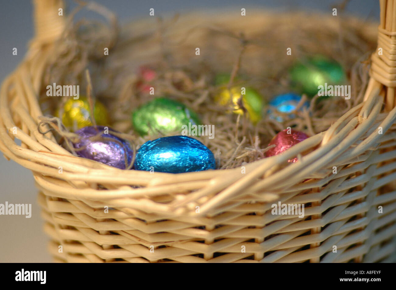 Colorful Easter Eggs in a Basket Stock Photo