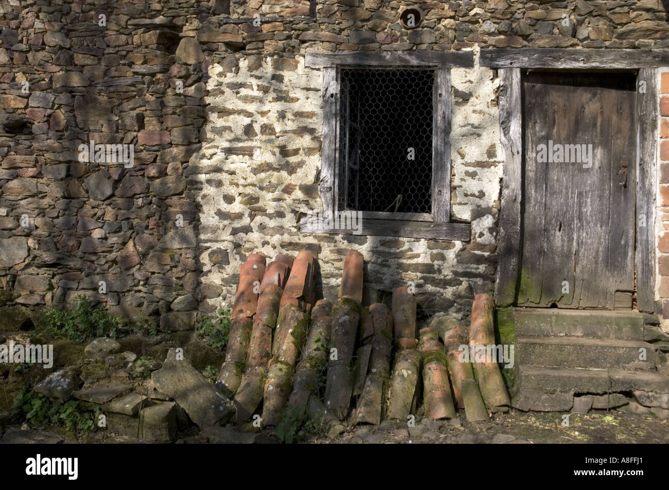 terracotta roof tiles lying next to the back door Stock Photo