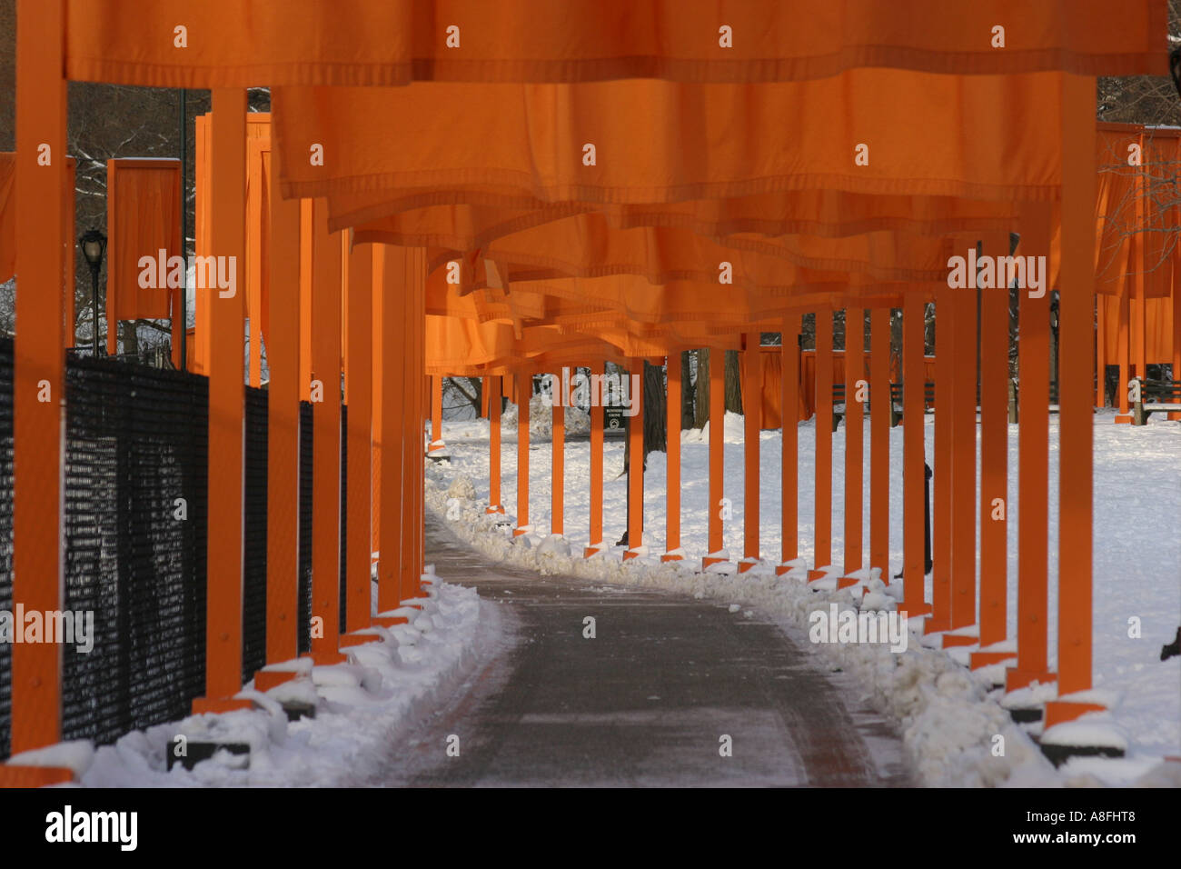 Suffron coloured gates forming a tunnel over a footpath in the Central of New York.  Christo and Jeanne-Claude Stock Photo