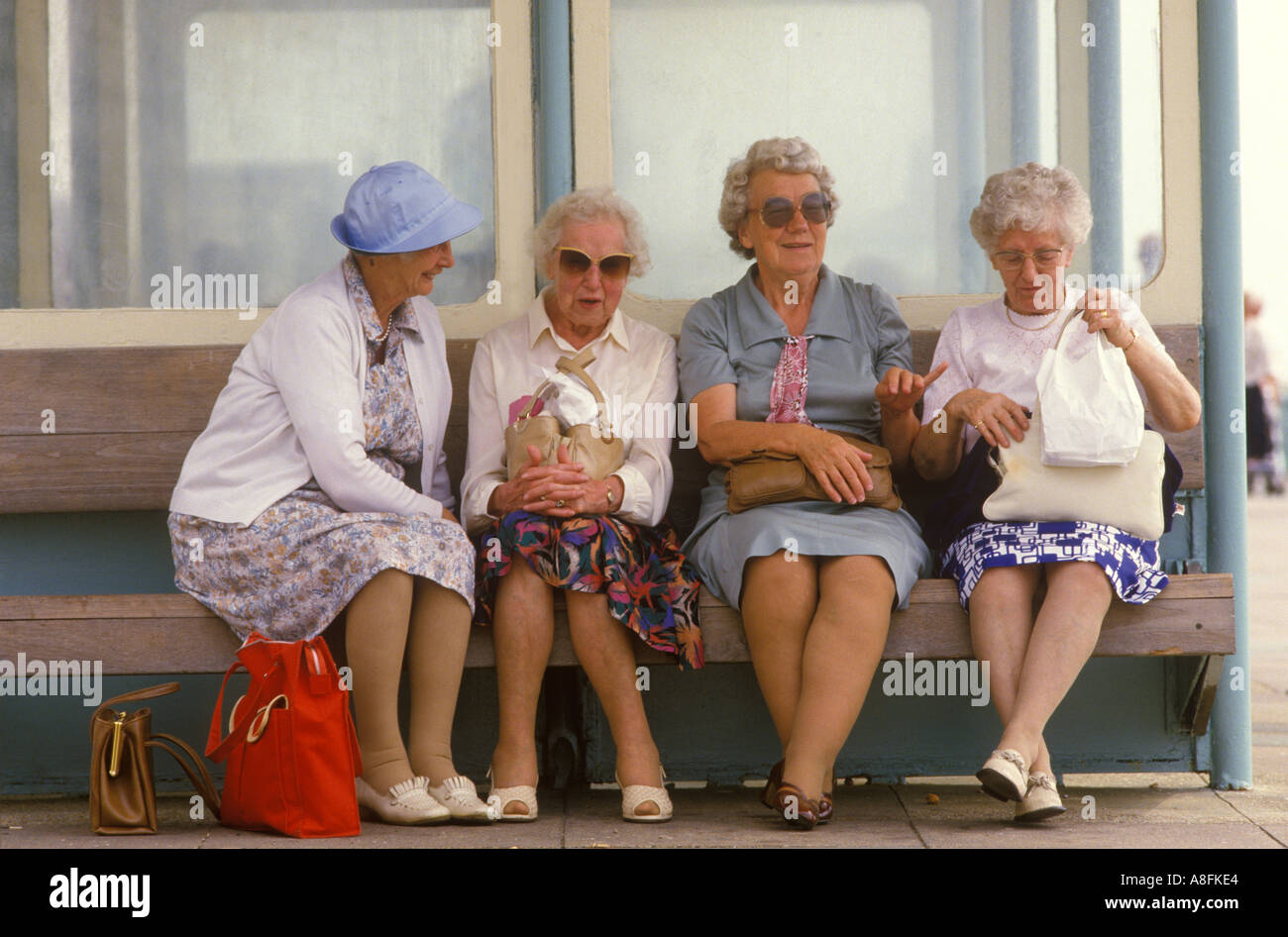 Four women old age pensioners enjoying a chat Brighton Sussex. Sitting in a wind shelter  1990s 90s HOMER SYKES Stock Photo
