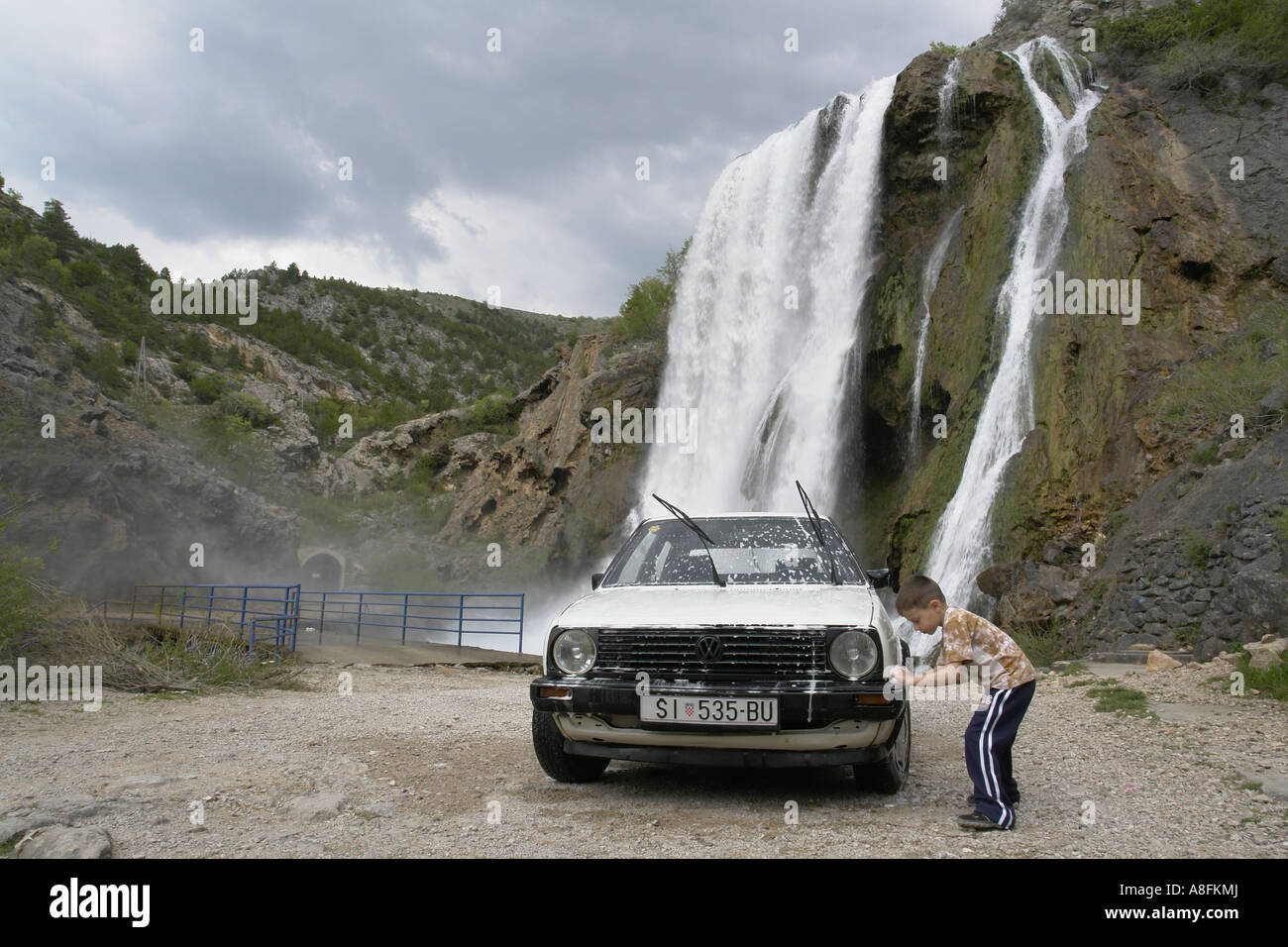 Car washing at Topolskij Buk waterfall source of Krka river near Knin