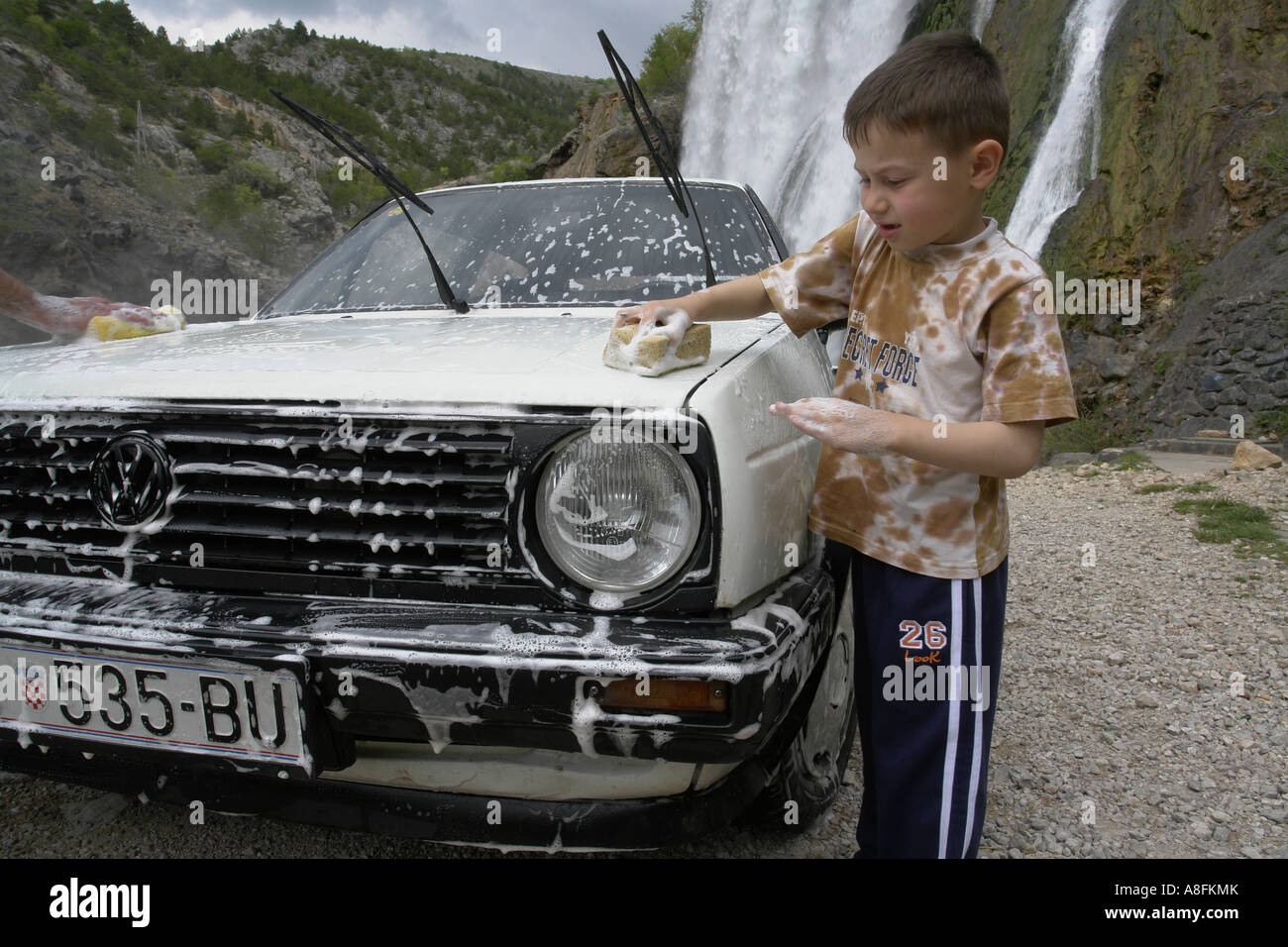 Car washing at Topolskij Buk waterfall source of Krka river near Knin