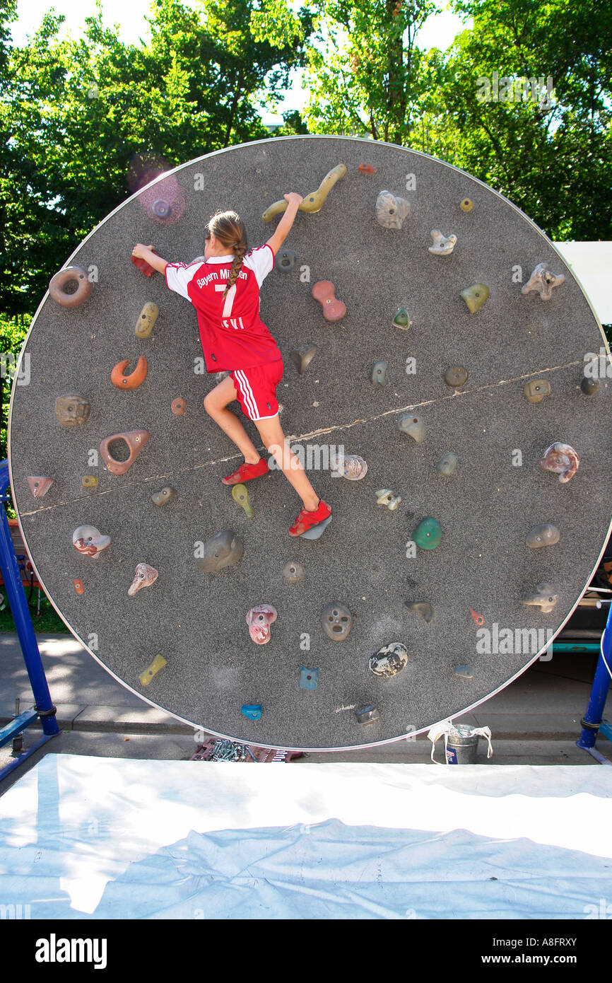 Children training rock climbing on a moving wall Stock Photo