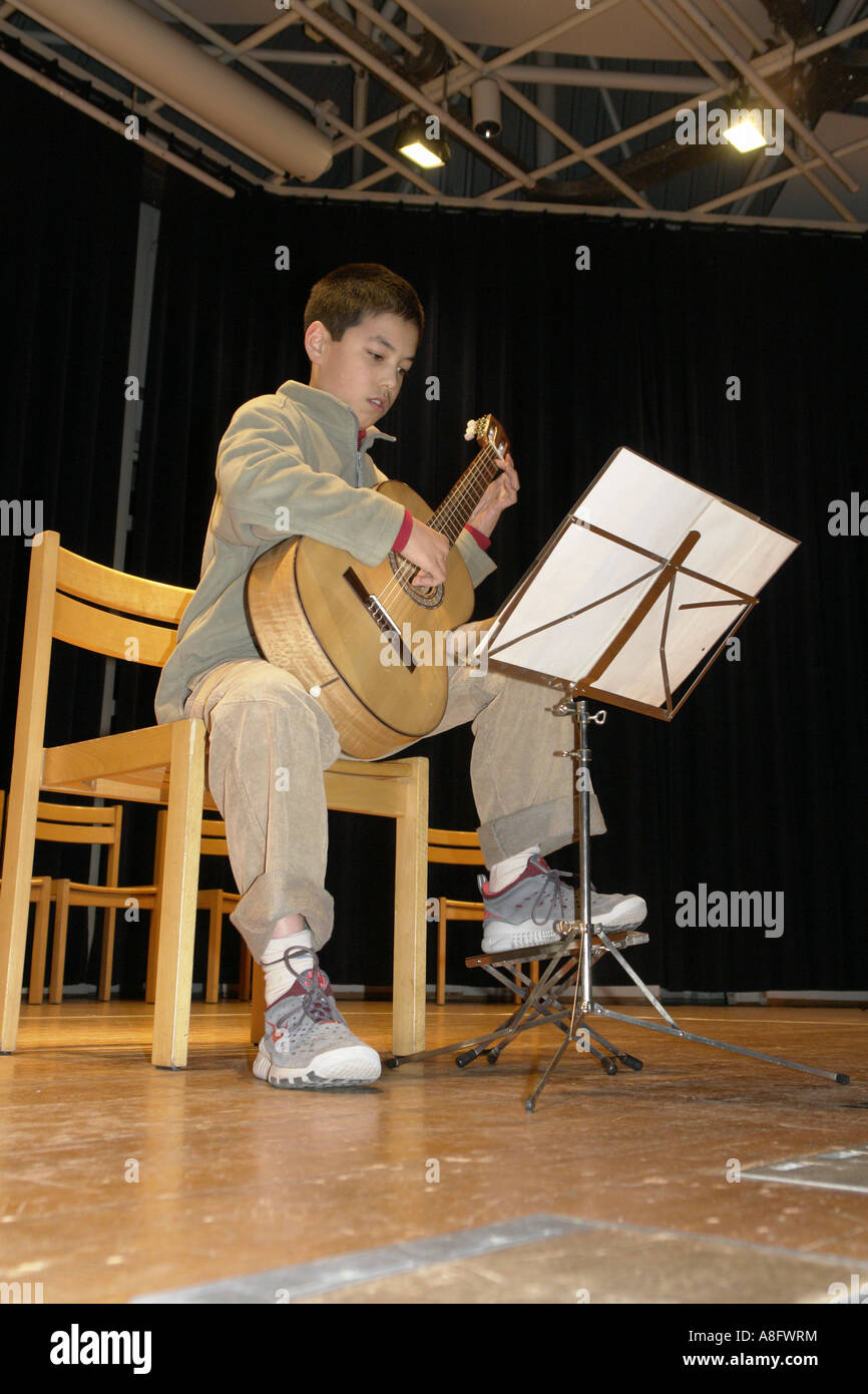 Boy play guitar on stage Stock Photo Alamy