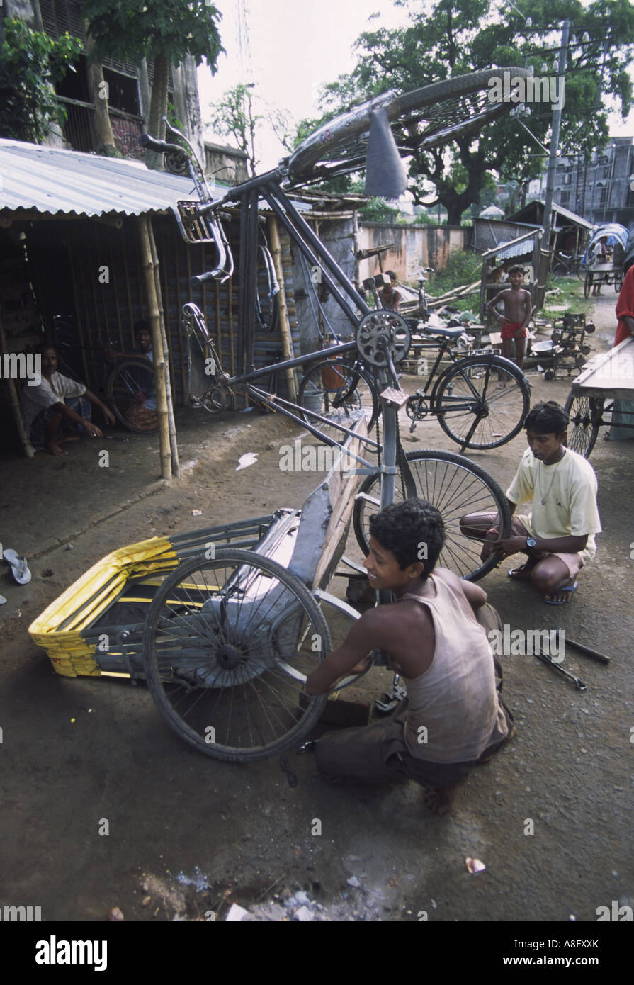 Bicycle and bicycle rikshaw repair shops on the side of the road near Murshidabad West Bengal India Stock Photo