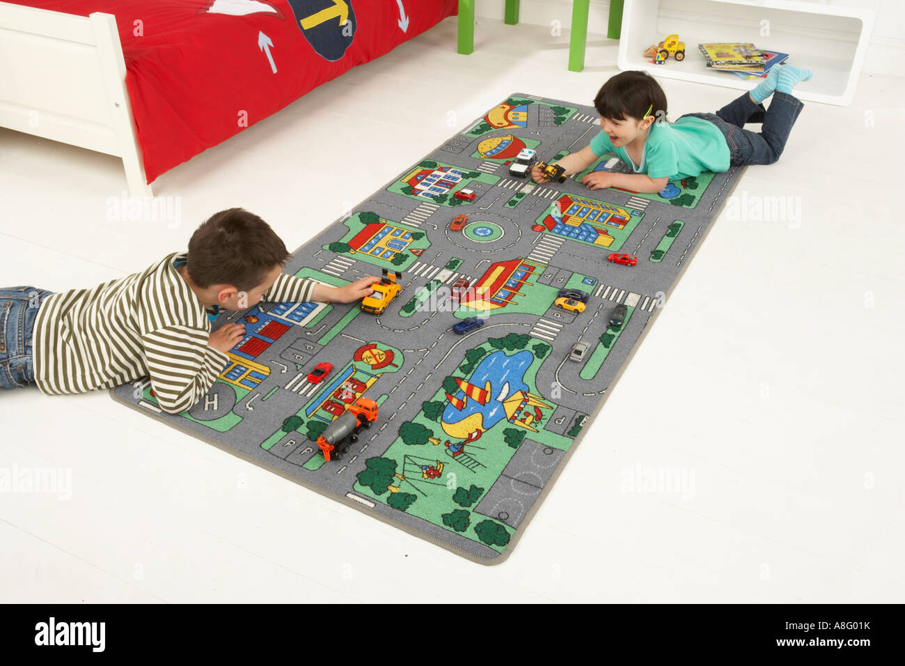 Two Boys Playing Cars On Car Mat In Bedroom Stock Photo 12092430