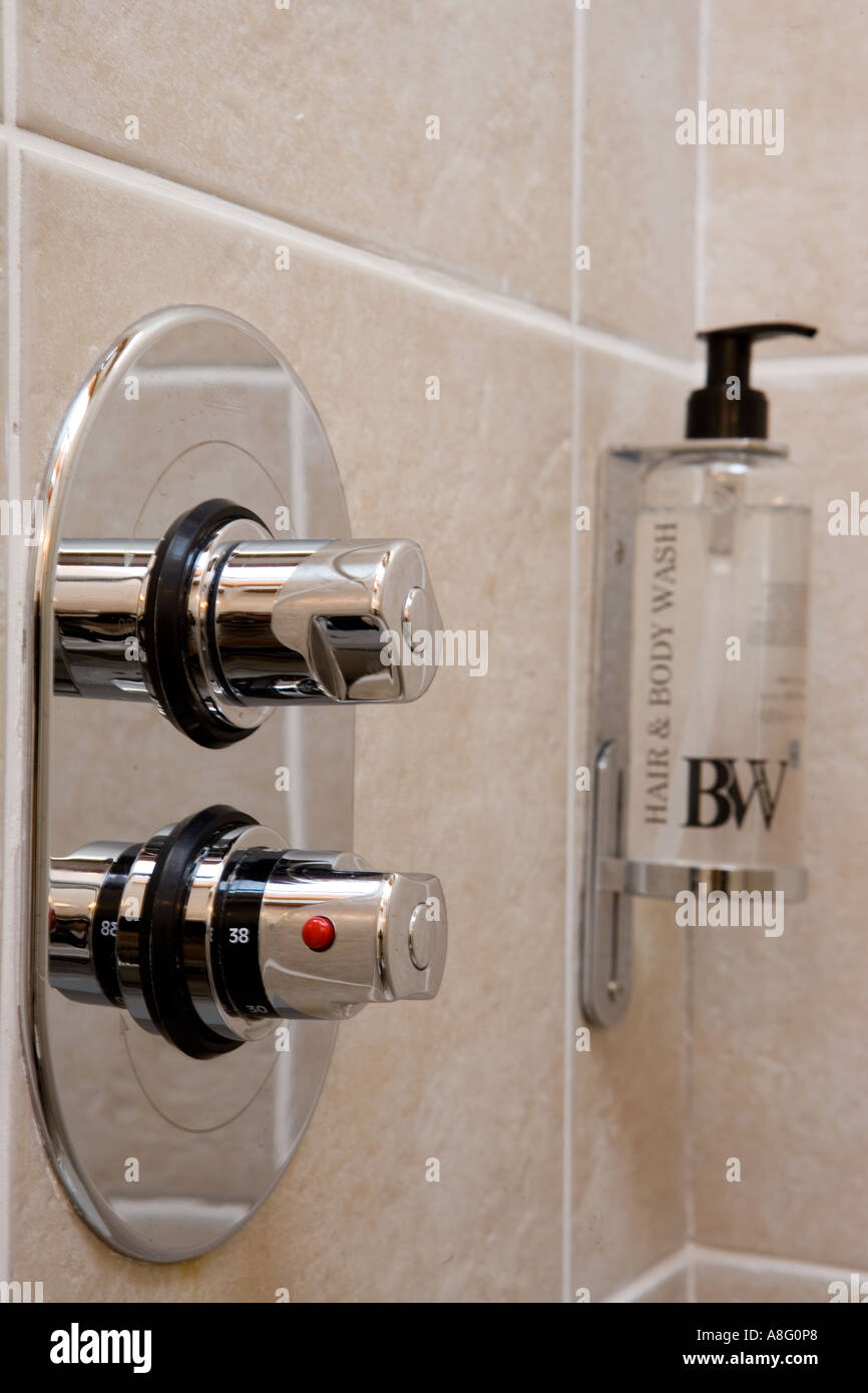 https://c8.alamy.com/comp/A8G0P8/close-up-of-shower-tap-controls-with-wall-mounted-soap-dispenser-A8G0P8.jpg