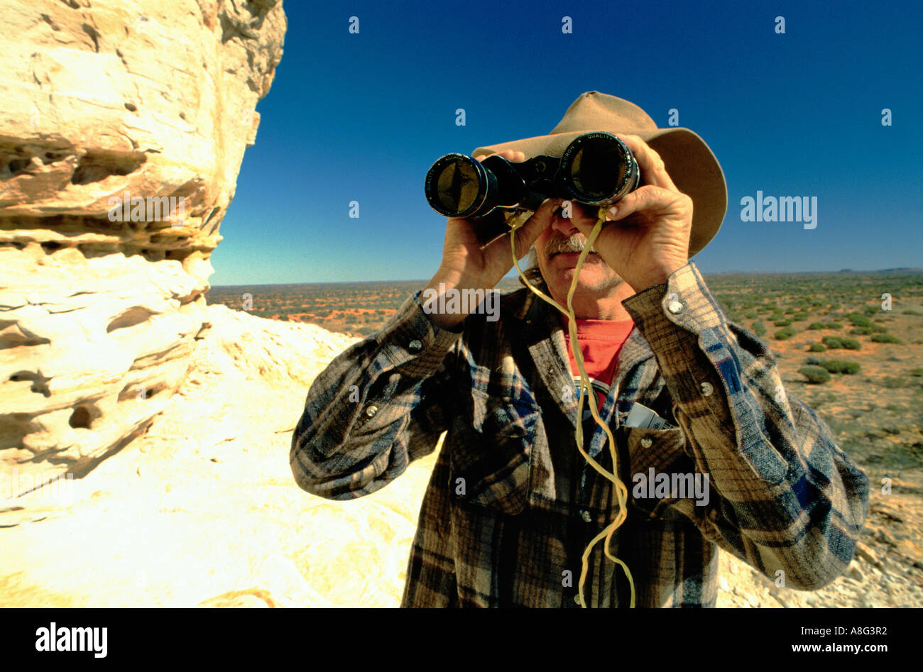 adventurer with binoculars, Caters Pillar, Northern Territory, Australia Stock Photo