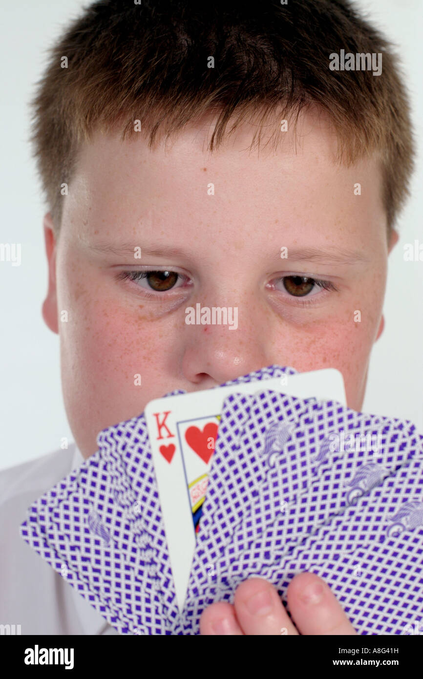 school-boy-holding-playing-cards-A8G41H.
