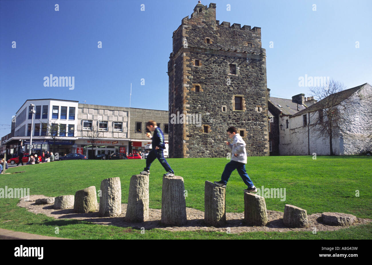 Kids playing on art work in front of the Castle of St John in Stranraer town centre Galloway Scotland UK Stock Photo