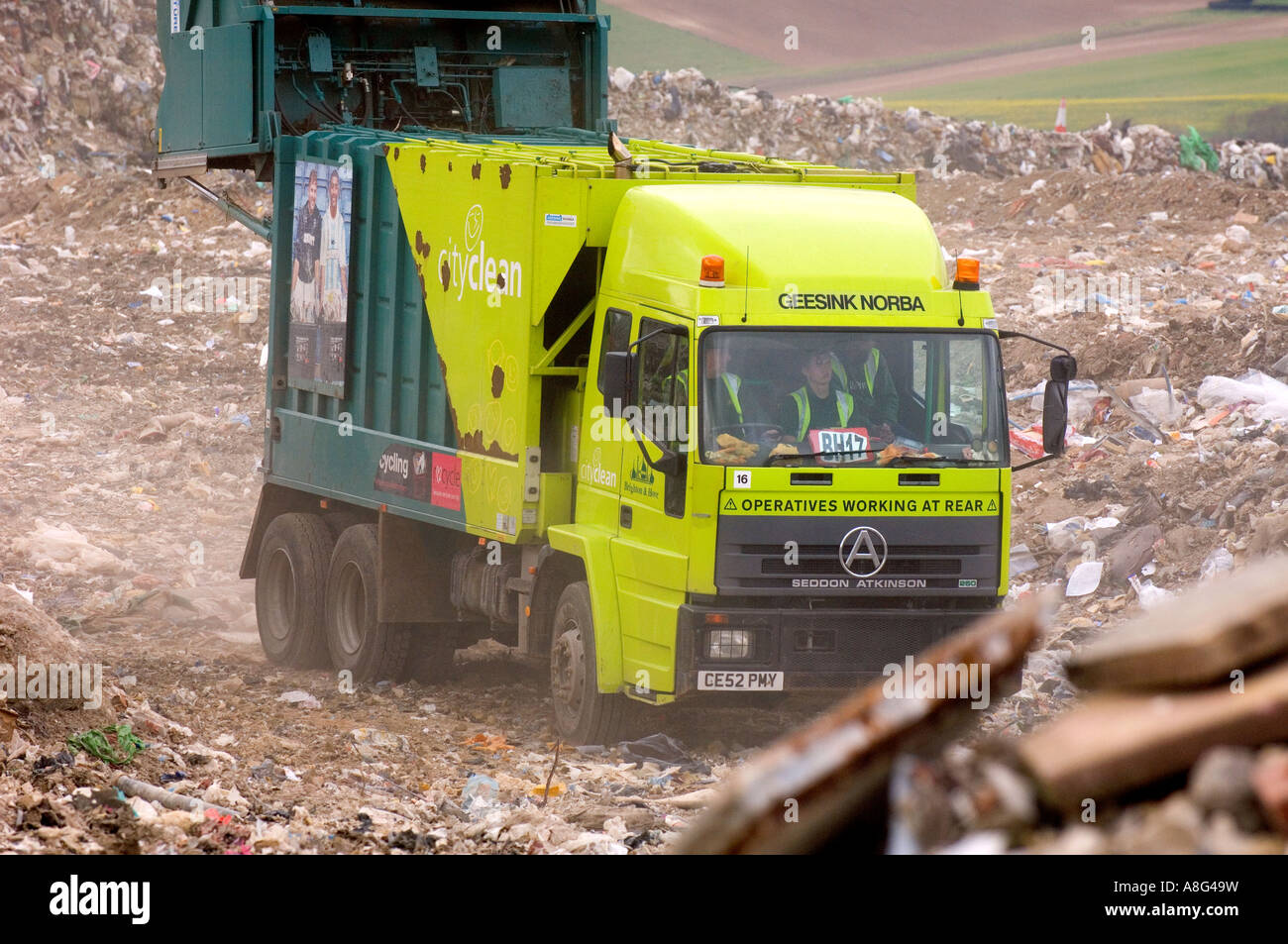 A busy landfill site in action with dustcarts refuse trucks and bulldozers. Beddingham, South East UK. Stock Photo