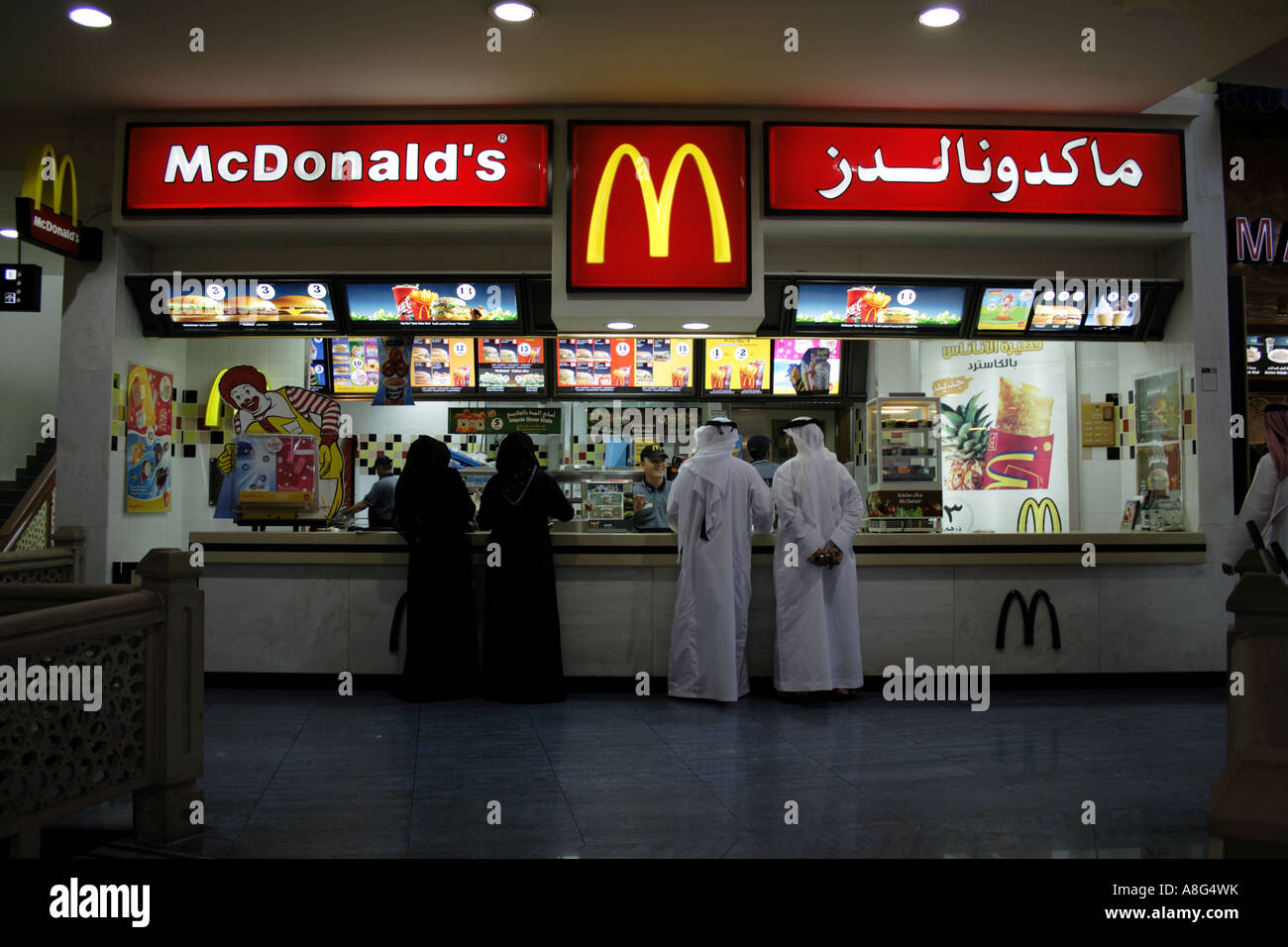 two arab men and women at Mc Donalds restaurant shopping mall at Rash Al Khaimah United Arab Emirates. Photo by Willy Matheisl Stock Photo