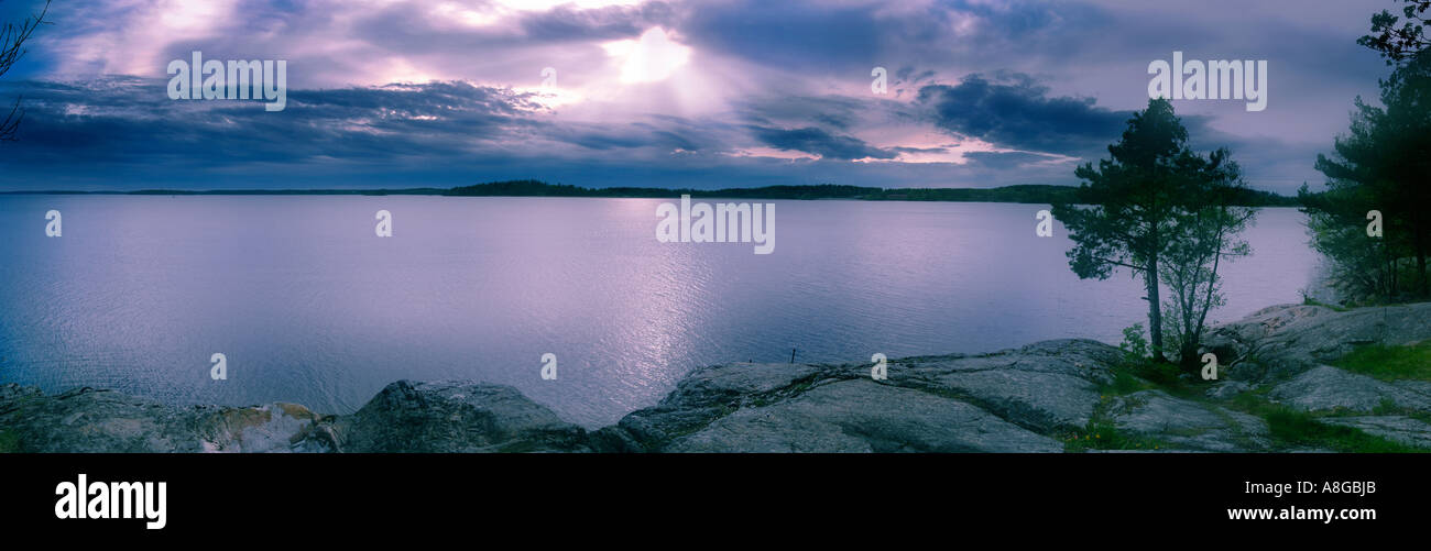 sunrays through a heavy cloud-cover over Lake Mälaren, Sweden Stock Photo