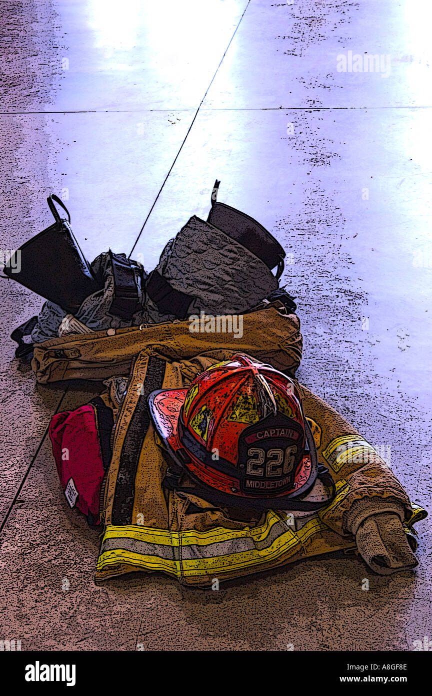Fire fighters protective equipment and helmet on floor Stock Photo