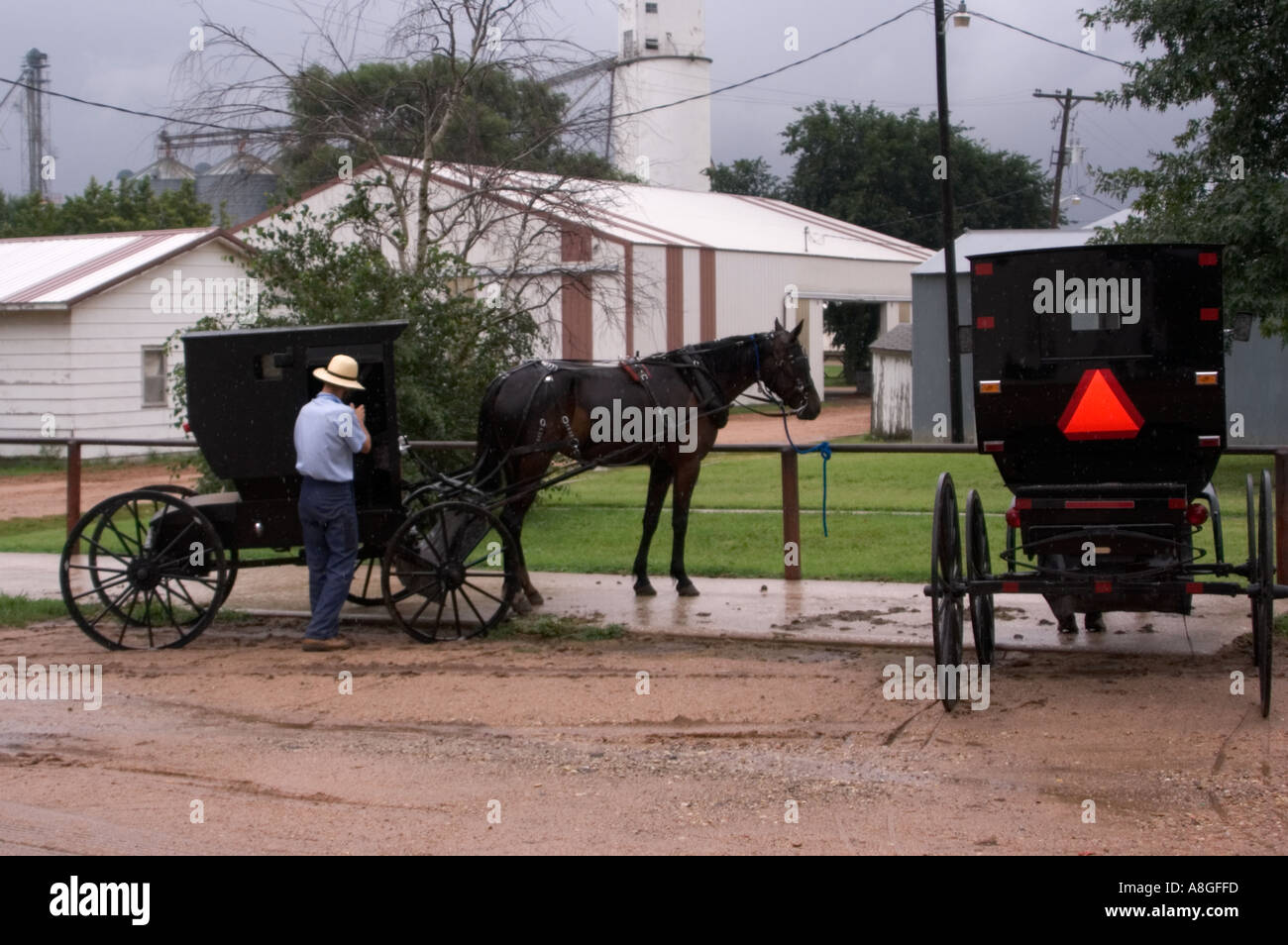 Amish Carriages Stopped on Side of Road with Man Yoder Kansas Stock