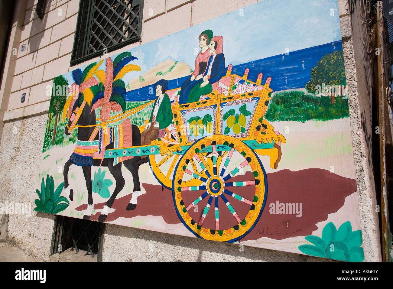 Wall mural of traditional Sicilian painted cart outside and