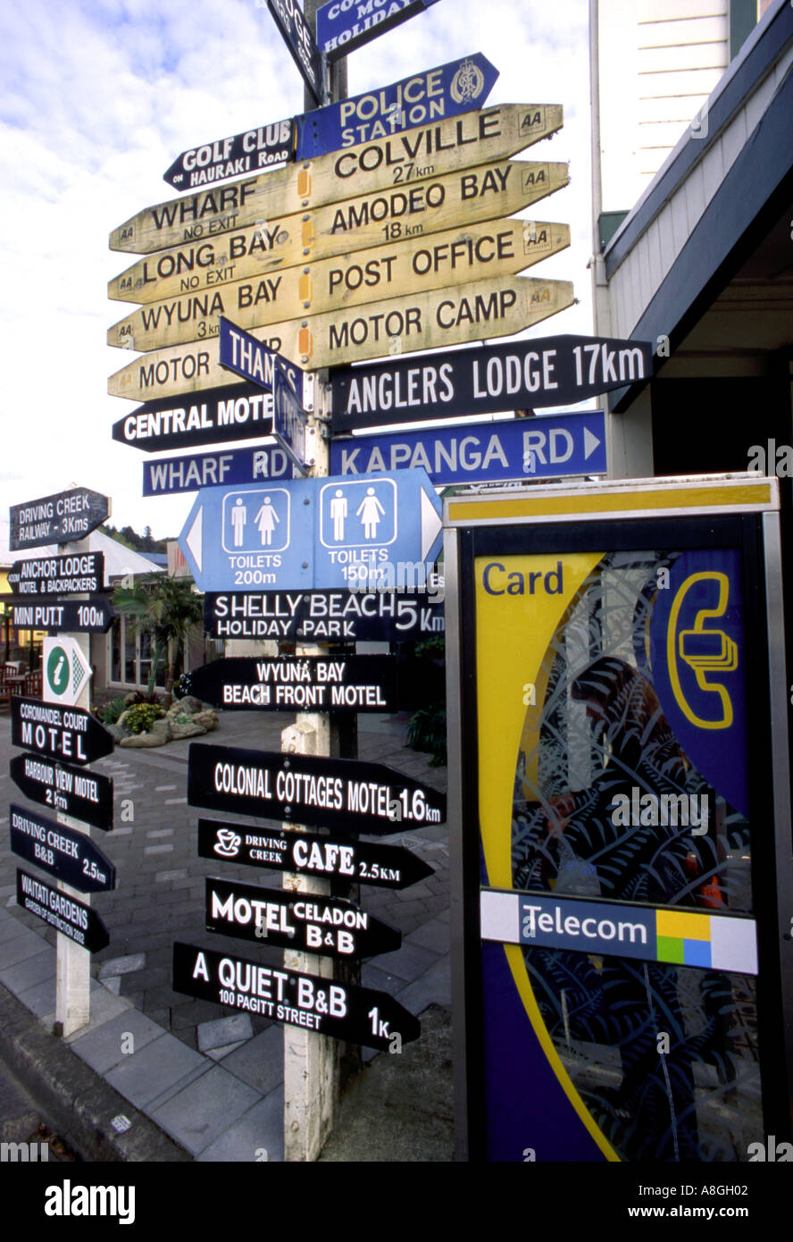 Multiple street sign and telephone box Coromandel Township North Island ...