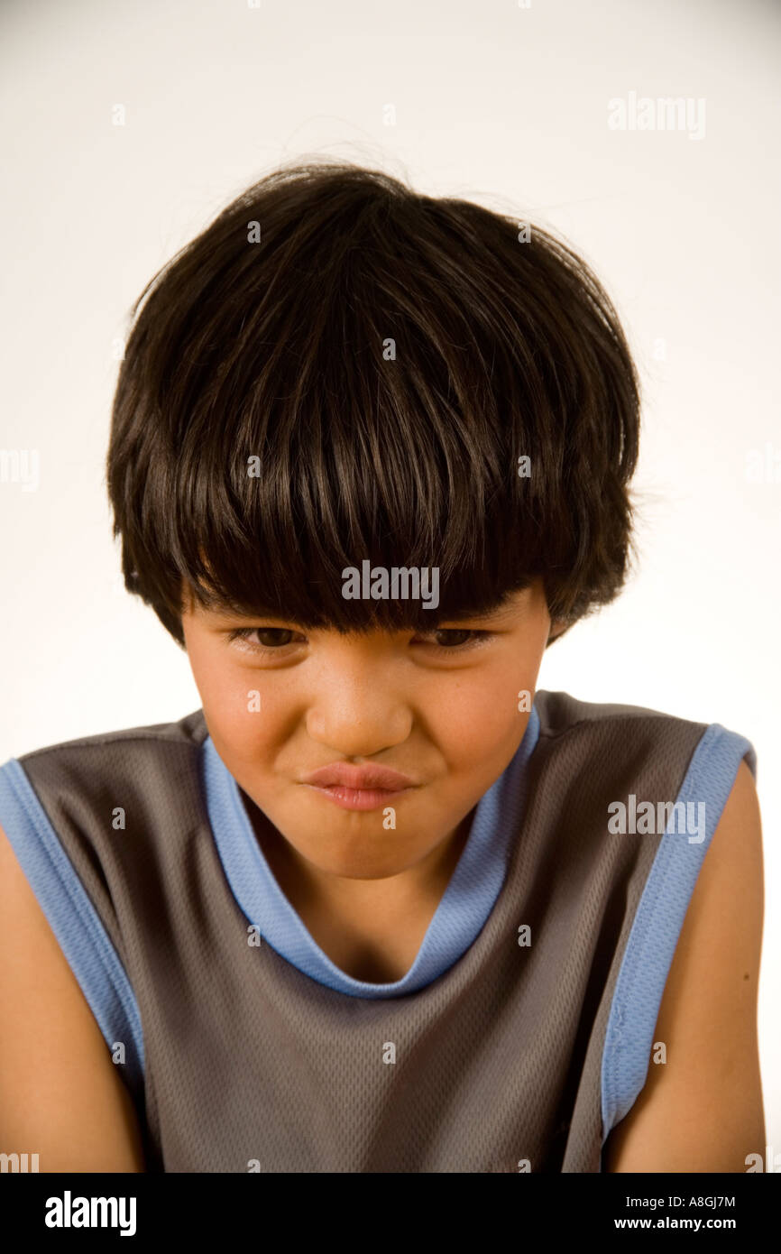 An 8 Year Old Chinese American Boy Wears A Contemplative Demeanor