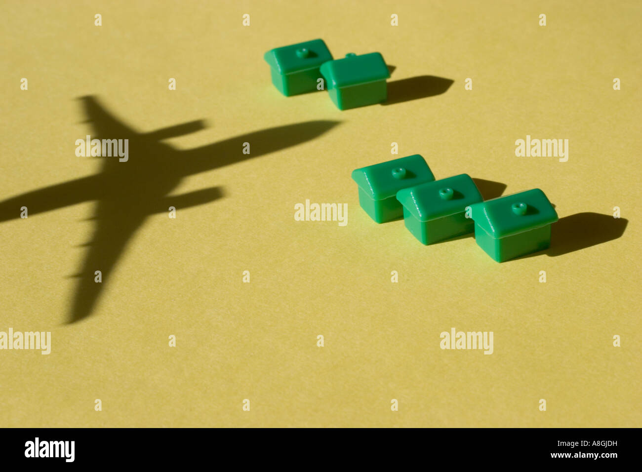 shadow of aircraft flying over monopoly houses Stock Photo