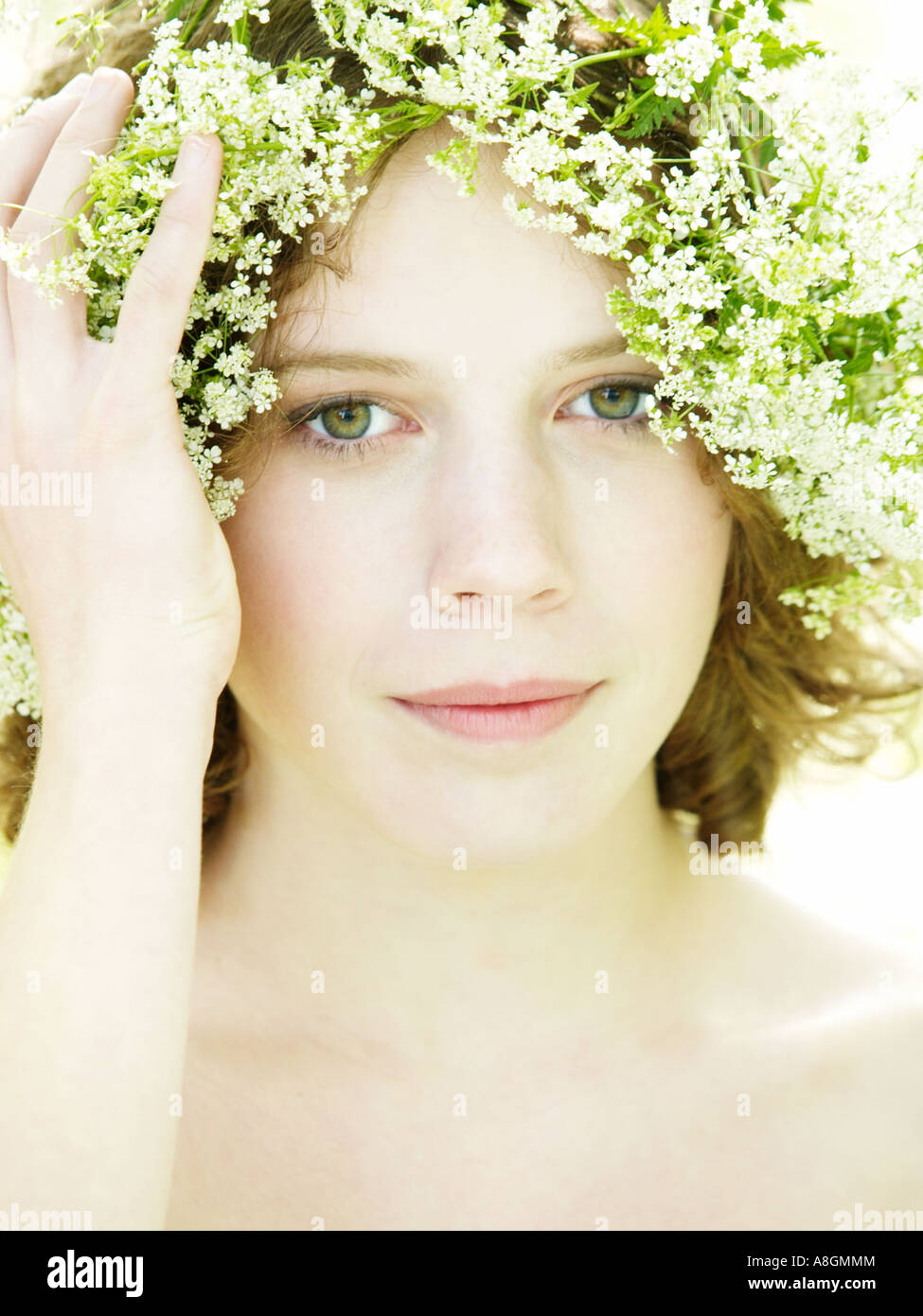 Teenage girl with green eyes and cow parsley wild chervil in her hair pale skin elph nimph summer spring Stock Photo