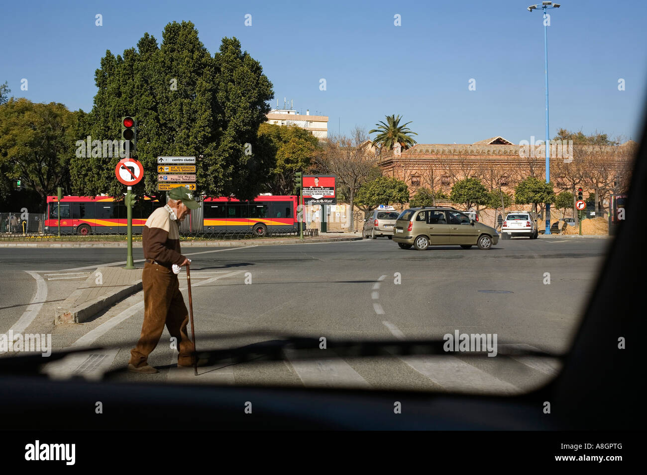 old man crossing a street in Seville Andalusia Spain Stock Photo