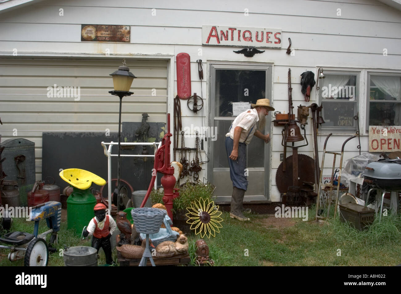 Amish man walking into antique store Yoder, Kansas Stock Photo