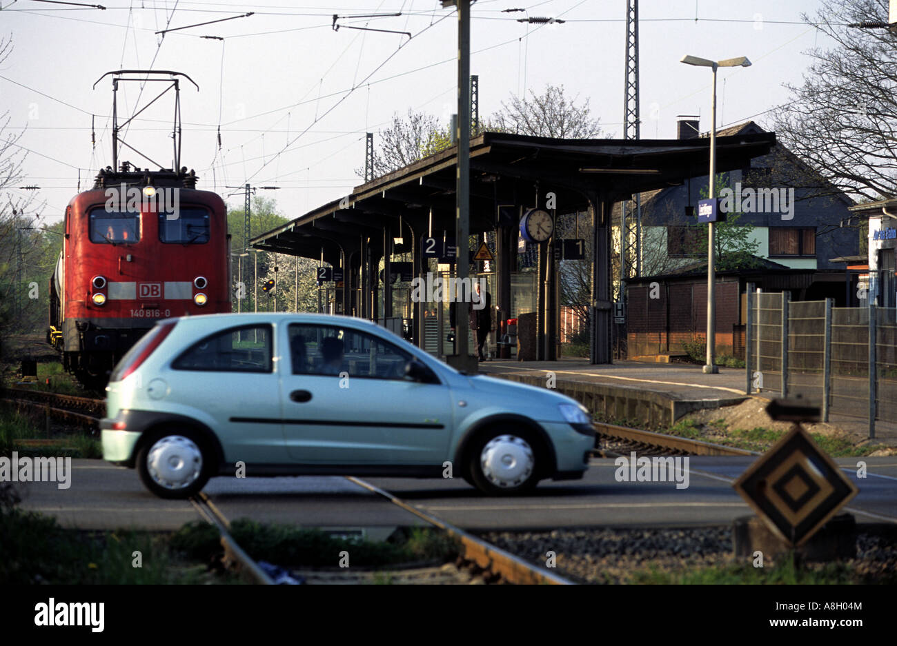 Car criossing a railway level crossing in front of an oncoming train, Leichlingen, North Rhine-Westphalia, Germany. Stock Photo