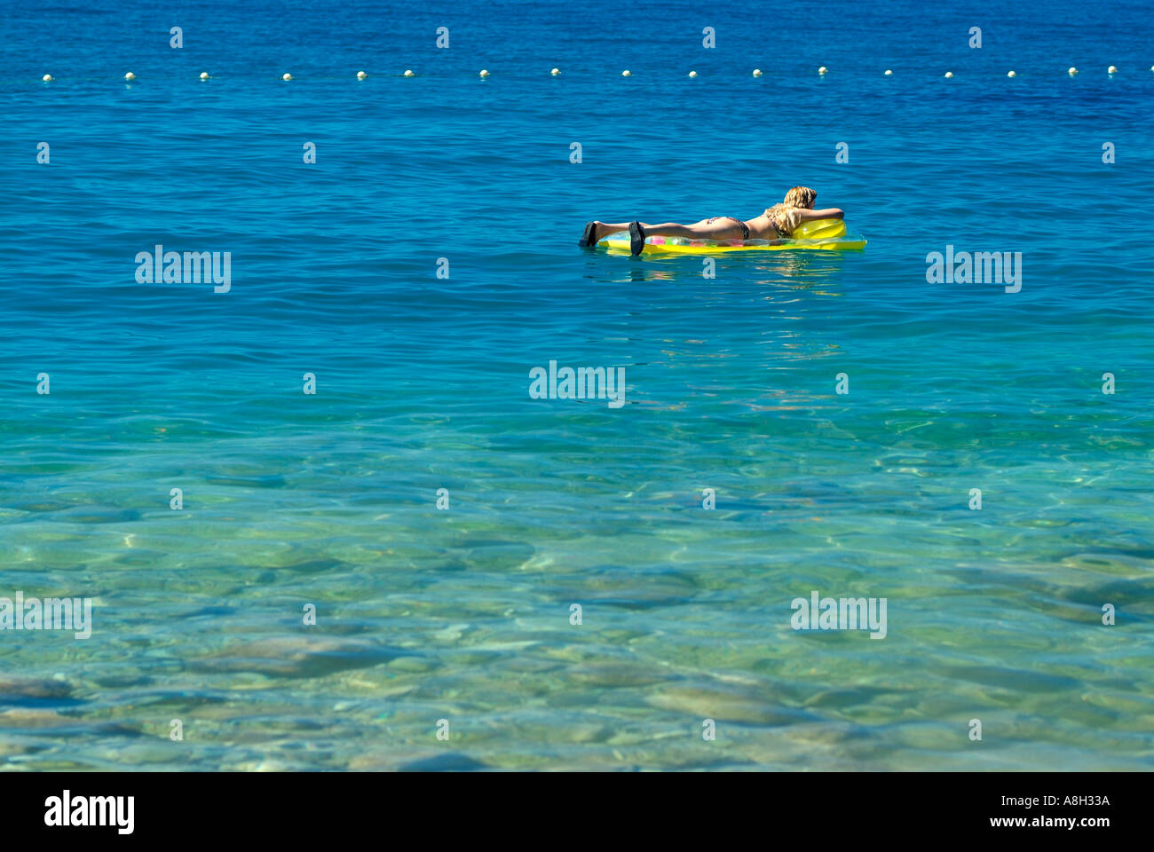 Holidaymaker Floating on a Lido in the Adriatic Sea off the Coast of Makarska, Dalmatian Coast, Croatia Stock Photo