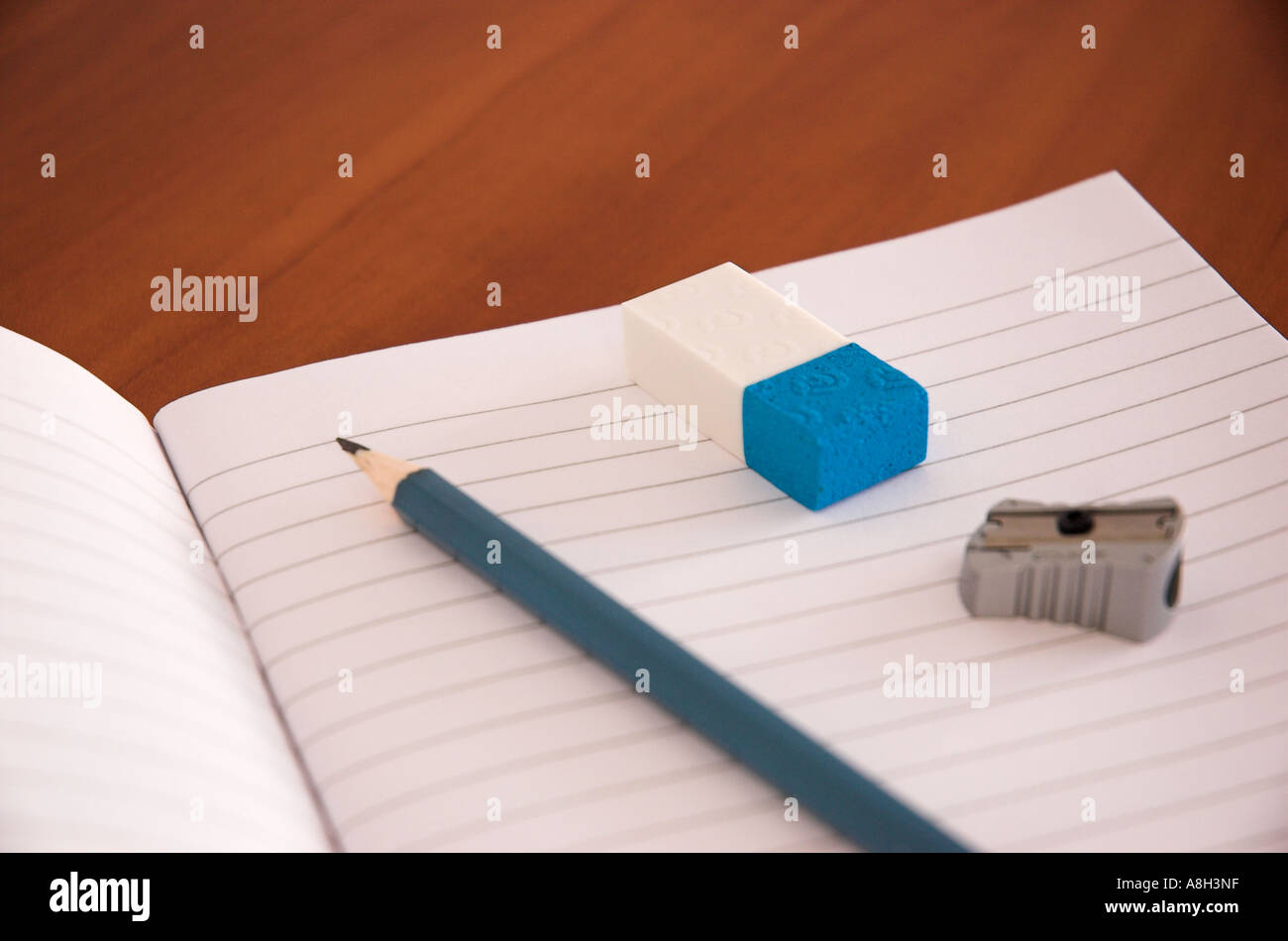 Exercise book pencil sharpener and eraser on school desk Stock Photo Alamy