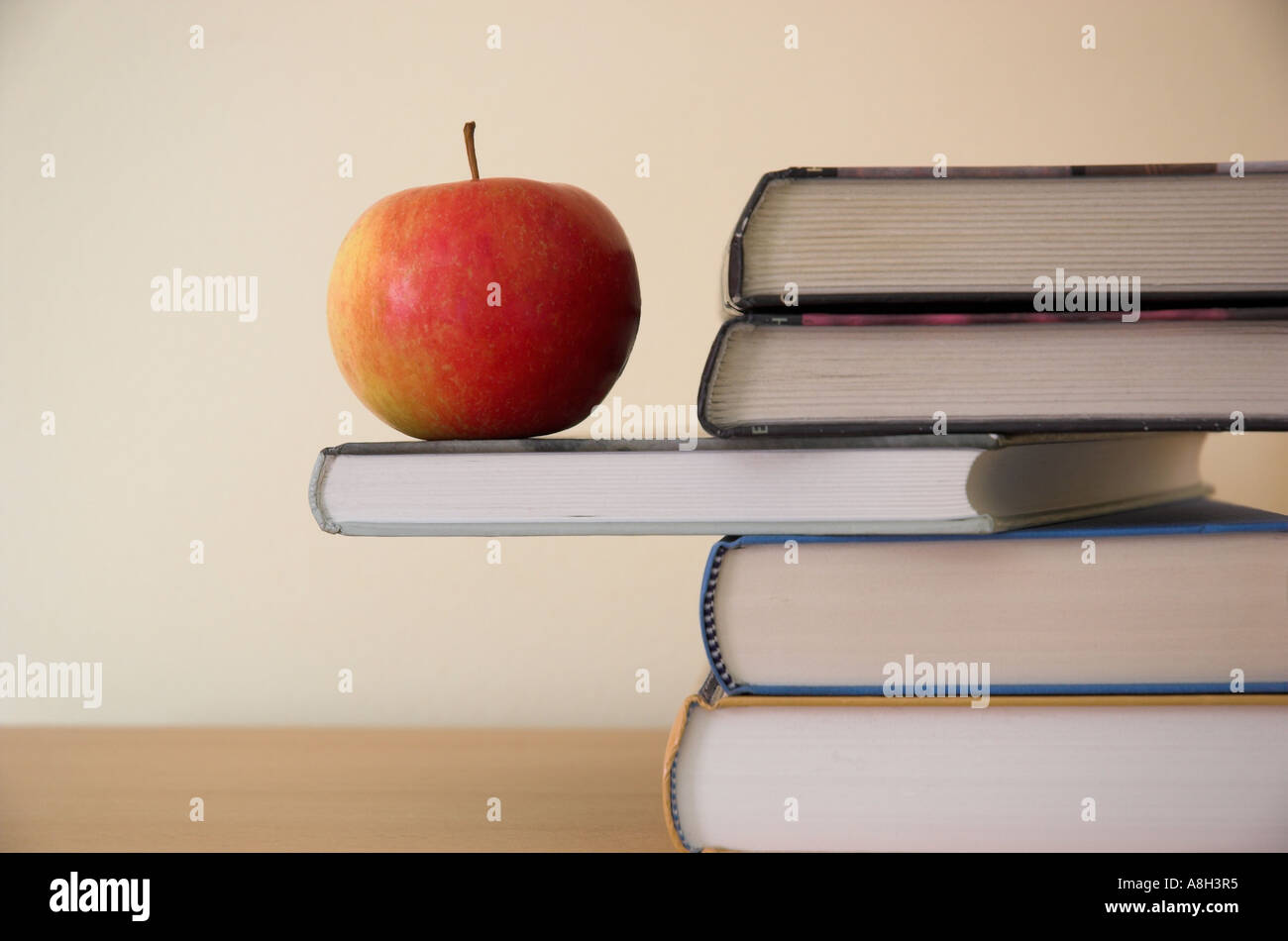 Red apple on textbook Stock Photo