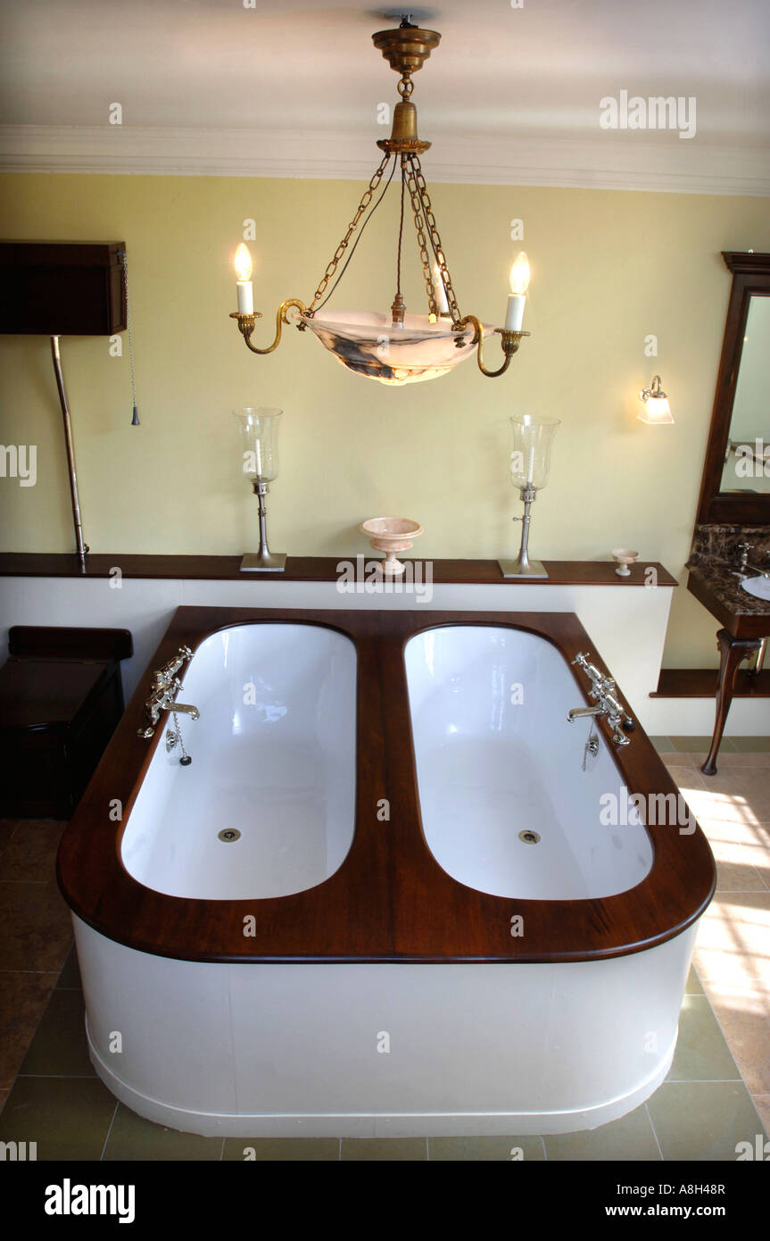 A LUXURY EN SUITE BATHROOM WITH A TWIN ANTIQUE BATH AT HALSWELL HOUSE