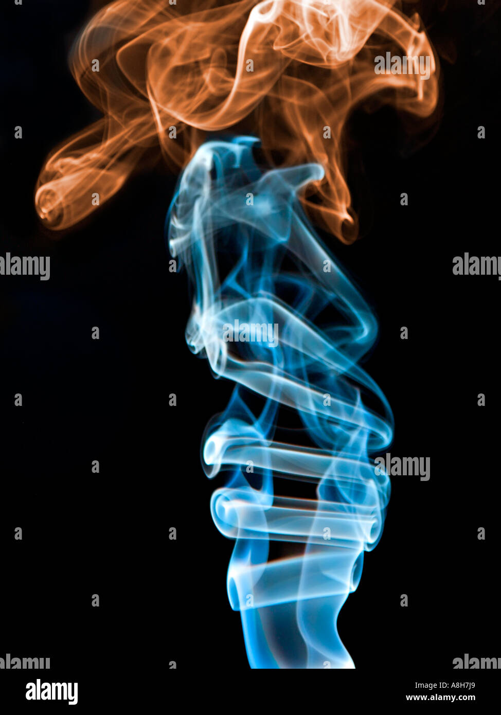 Colorized incense smoke trails on a black background Stock Photo