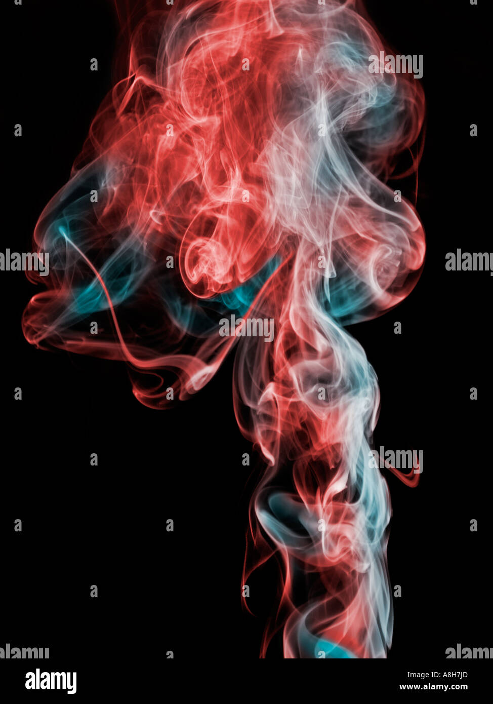 Colorized incense smoke trails on a black background Stock Photo