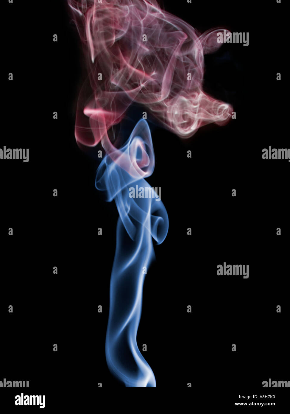 Colorized incense smoke trails on a black background Stock Photo