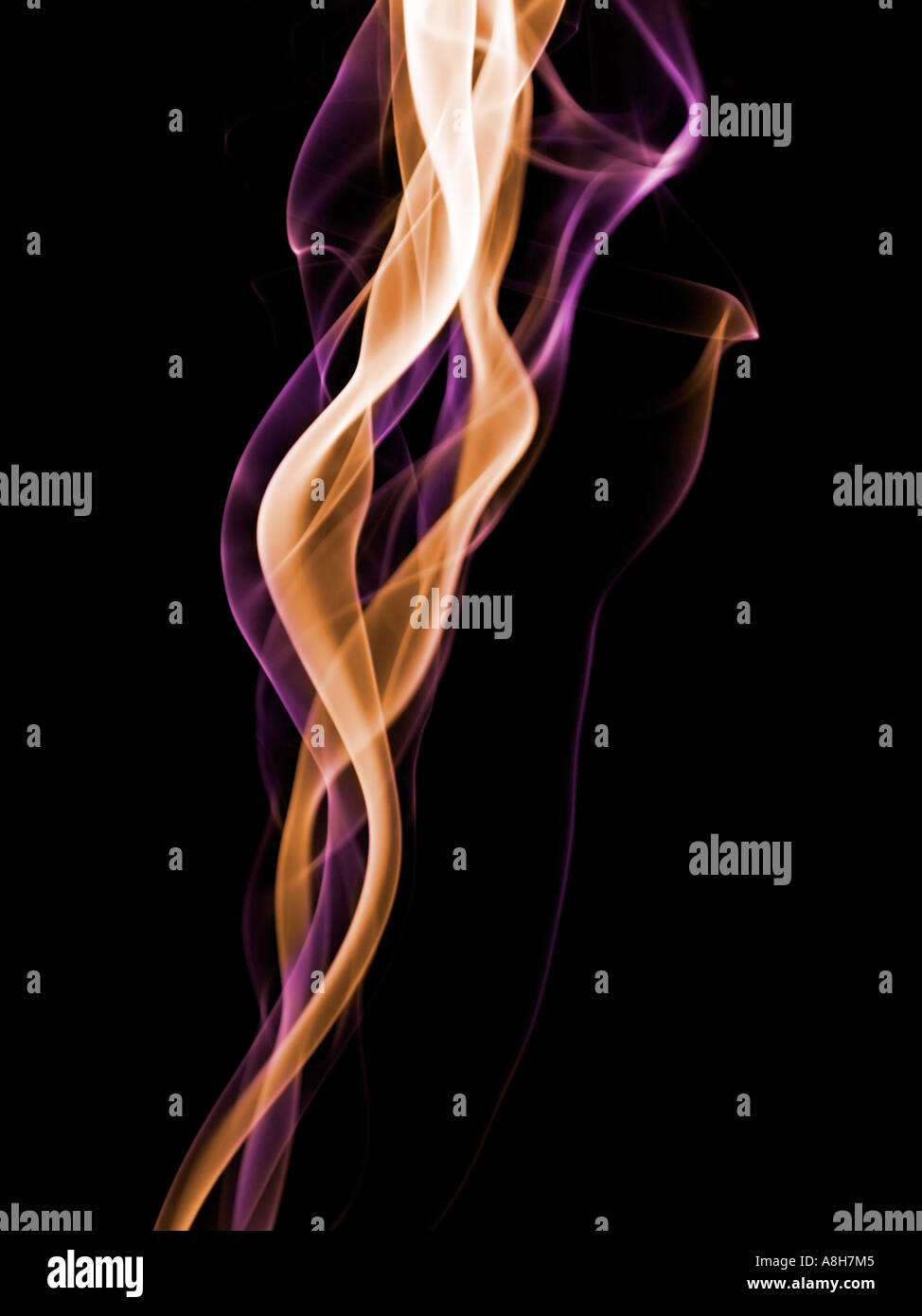 Colorized incense smoke trails on a black background Stock Photo