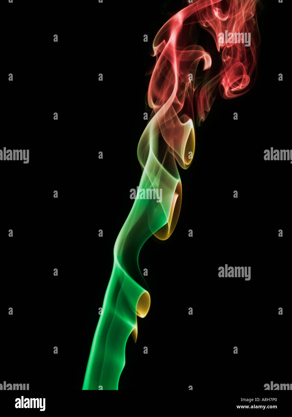 Colorized incense smoke trails on a black background Stock Photo