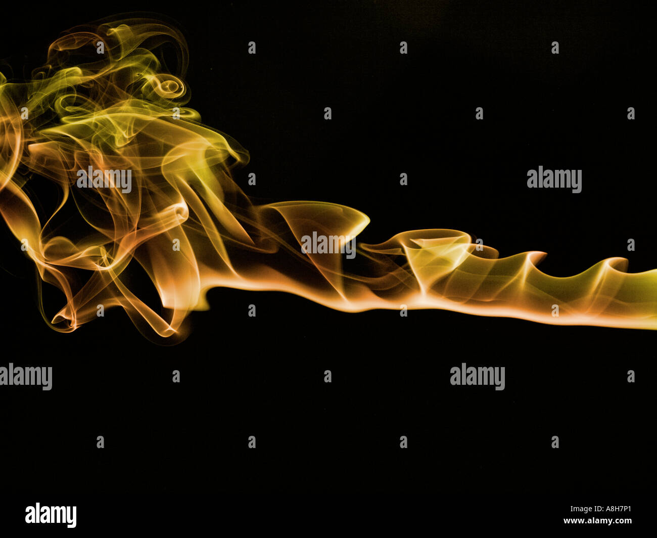 Colorized incense smoke trails on a black background Stock Photo