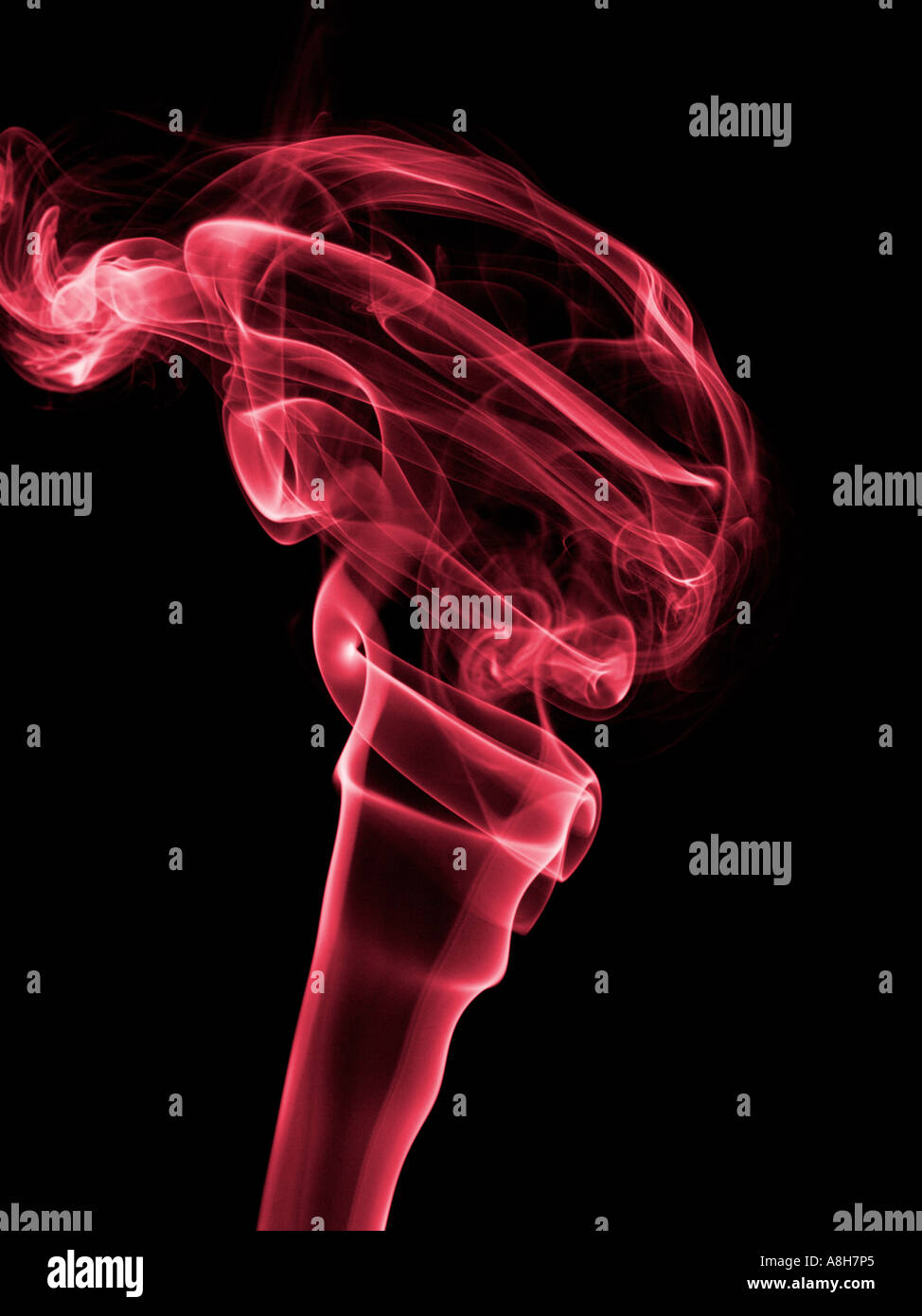 Colorized incense smoke trails on a black background Stock Photo