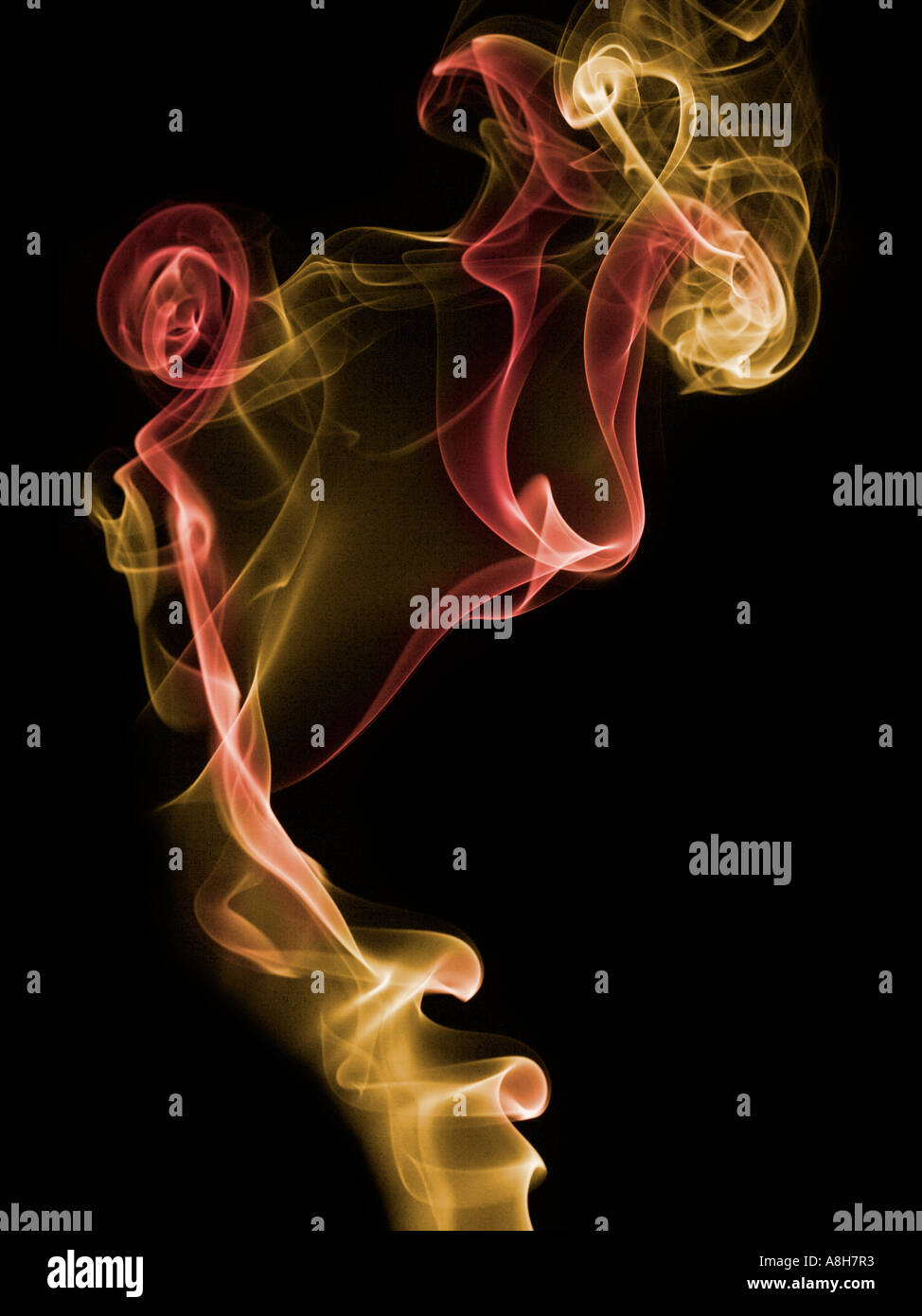 Colorized incense smoke trails on a black background Stock Photo