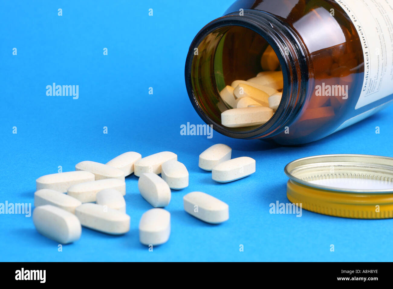 Vitamin C tablets flowing from a container Stock Photo Alamy