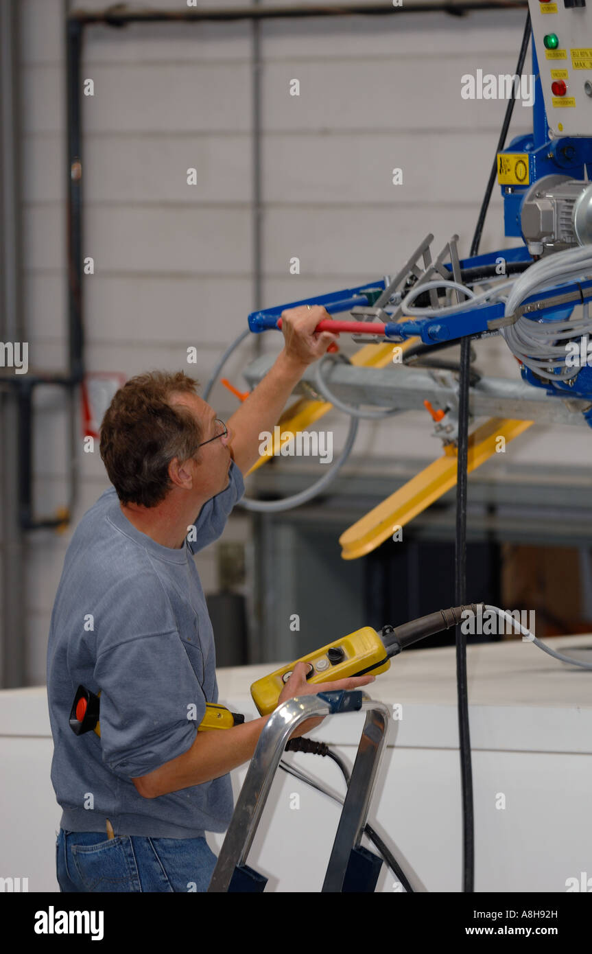 Overview from Men at work by camper wih hoisting crane Camper builder