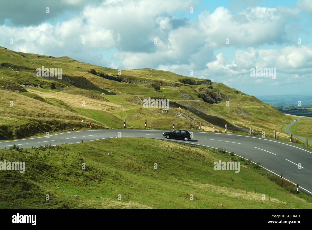 Brecon Beacons National Park typical unfenced road with car driving