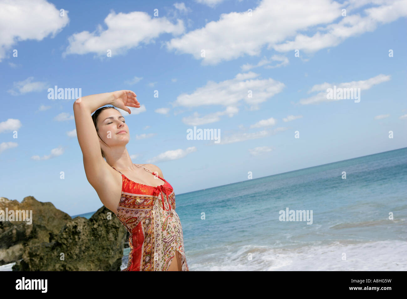 A young woman standing on a beach Stock Photo - Alamy