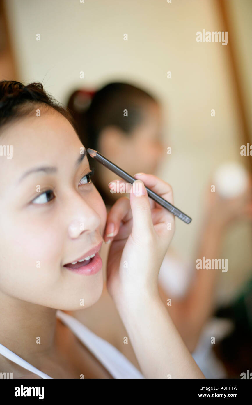 Smiling asian woman applying hair hi-res stock photography and images ...