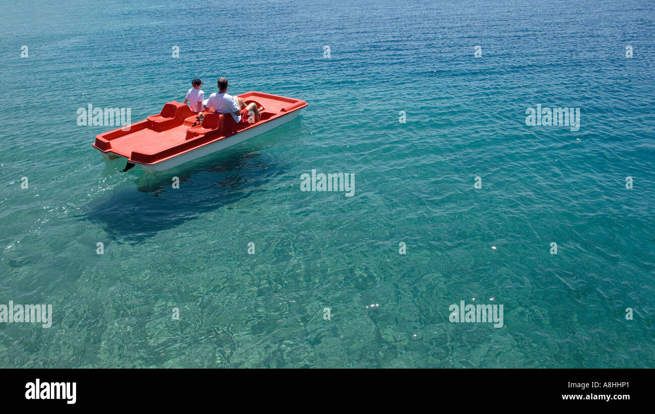 European holidaymakers on a pedalo Father and son at Nuweiba on the Red Sea Coast Crystal clear waters Sinai Egypt Stock Photo