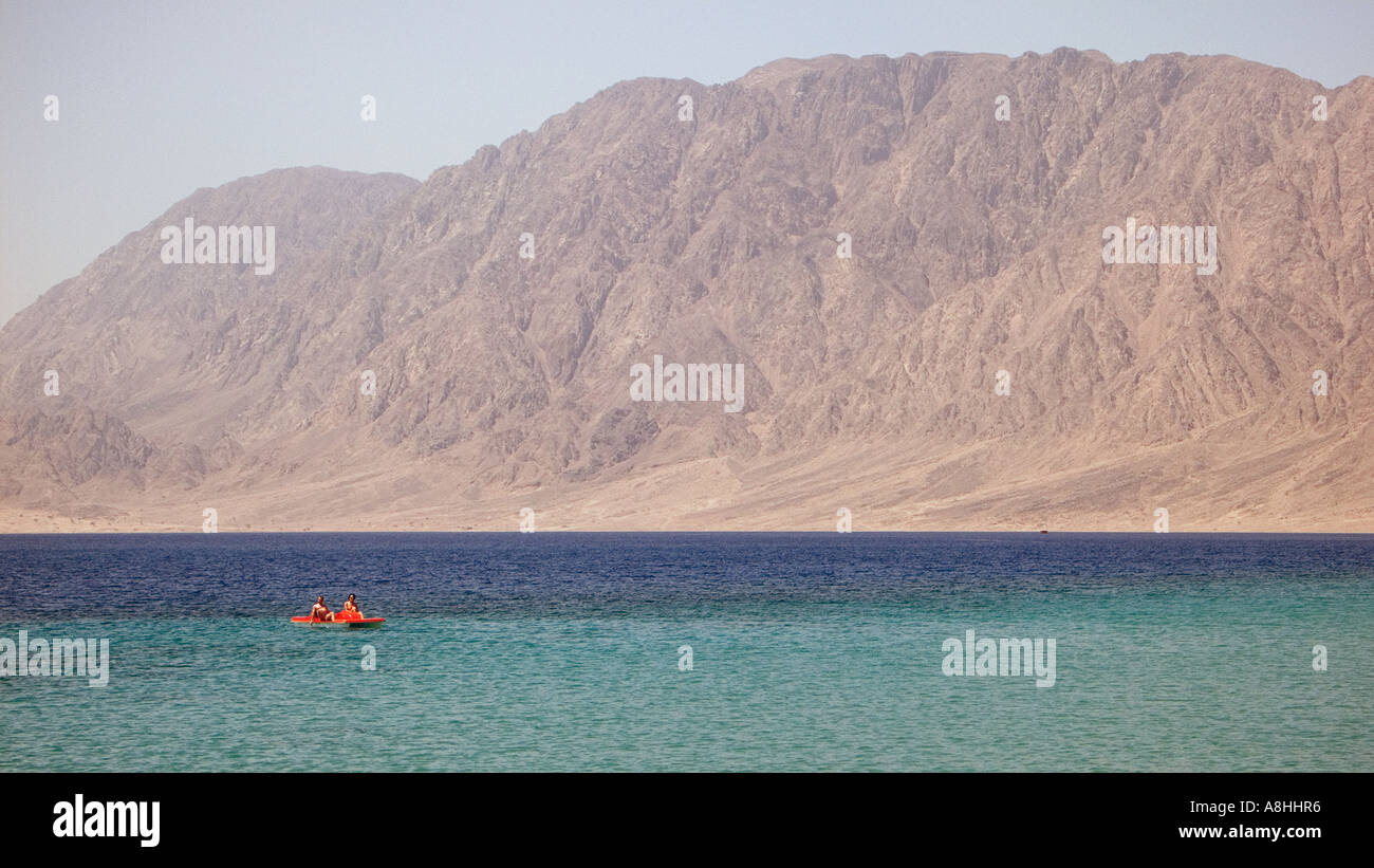 European holidaymakers on a pedalo set against the coastal mountains of the Red Sea Sinai Egypt Stock Photo