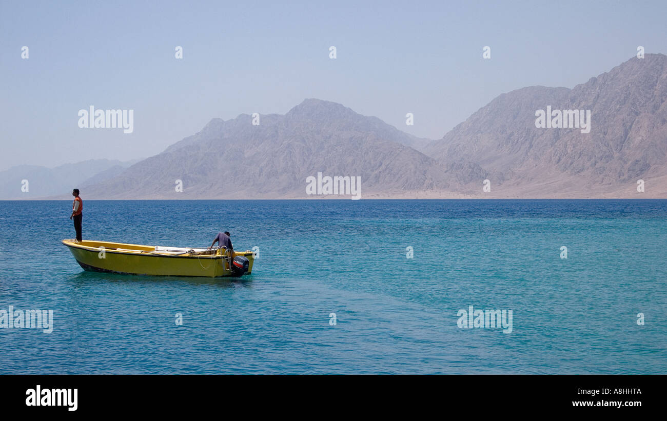 Yellow boat and crew at Nuweiba on the Red Sea Coast Coastal mountains south of Nuweiba and north of Sharm El Sheikh Sinai Egypt Stock Photo