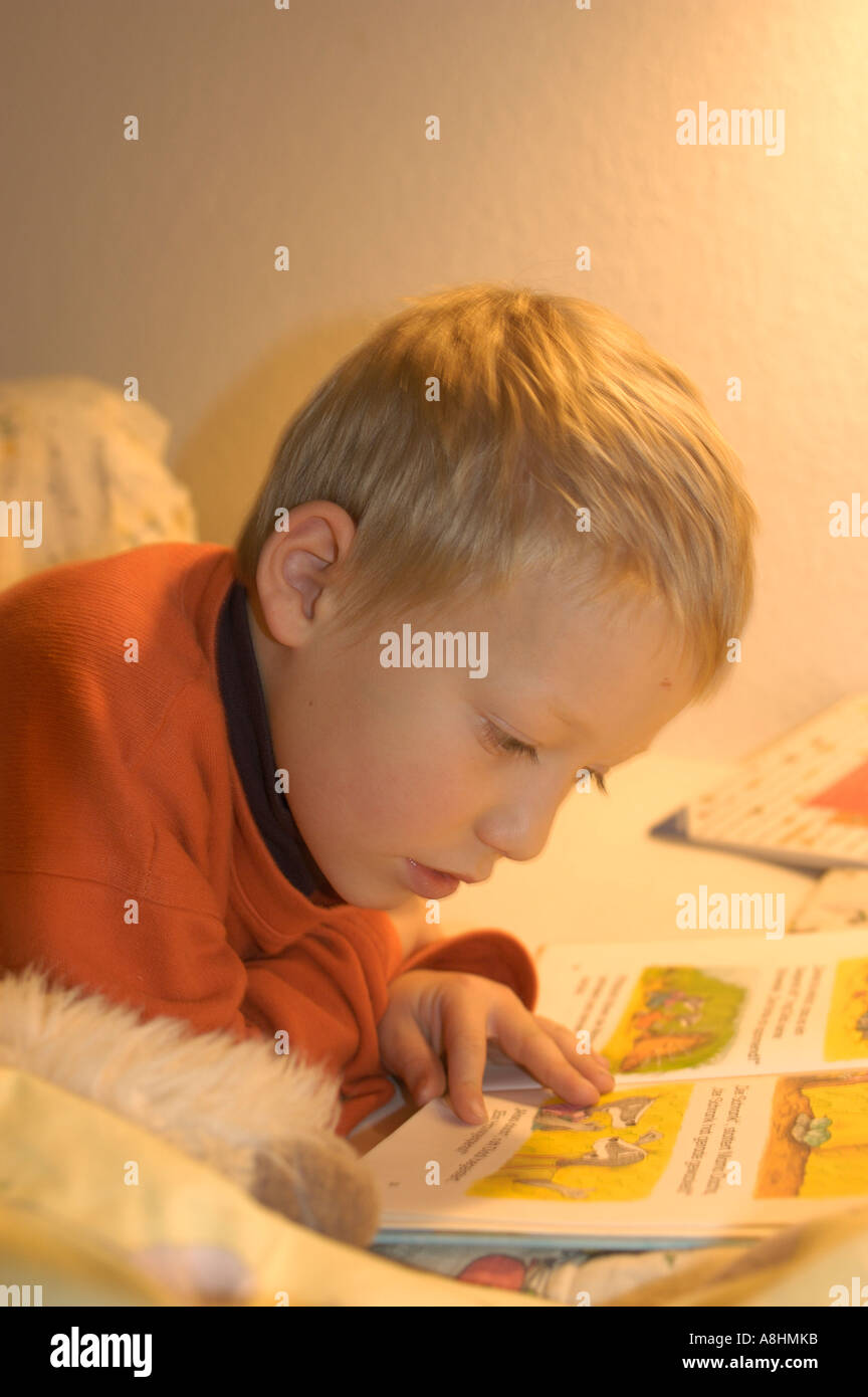 Seven year old boy is reading a book Stock Photo Alamy