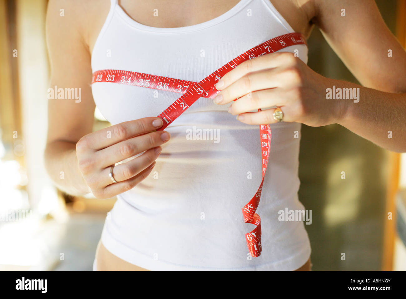 Midsection of a woman measuring her body Stock Photo - Alamy
